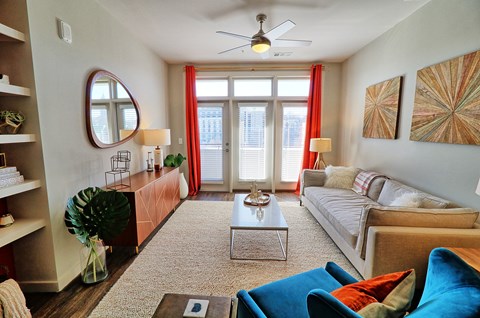 a living room with a couch and a coffee table and a window